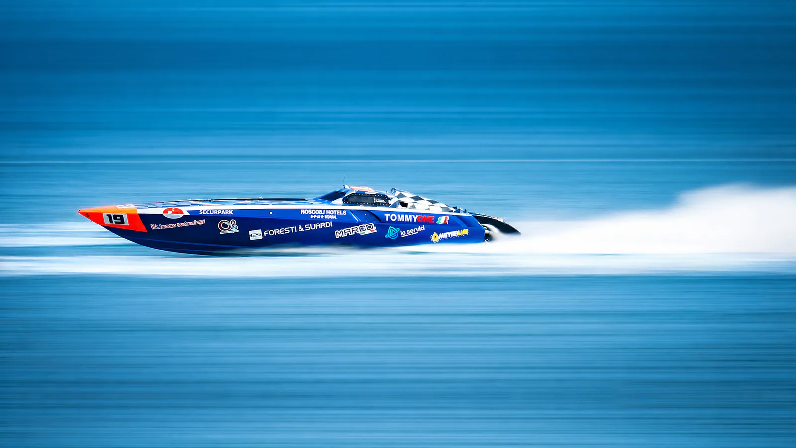 Tommy One racing at high speed in clean side profile